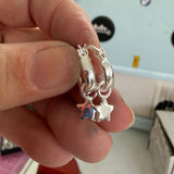 Special interchangeable huggie hoop earrings.
